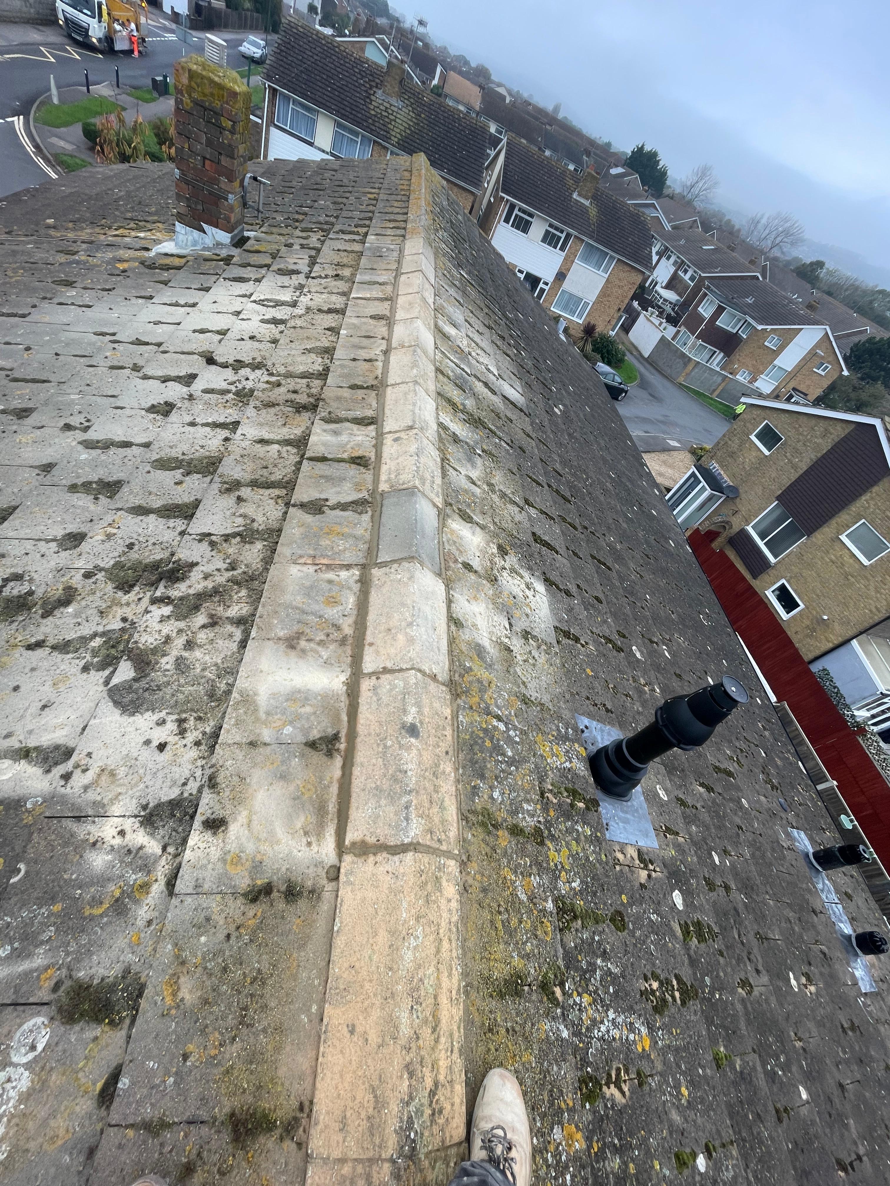 Repointed roof ridge tiles with fresh mortar bedding
