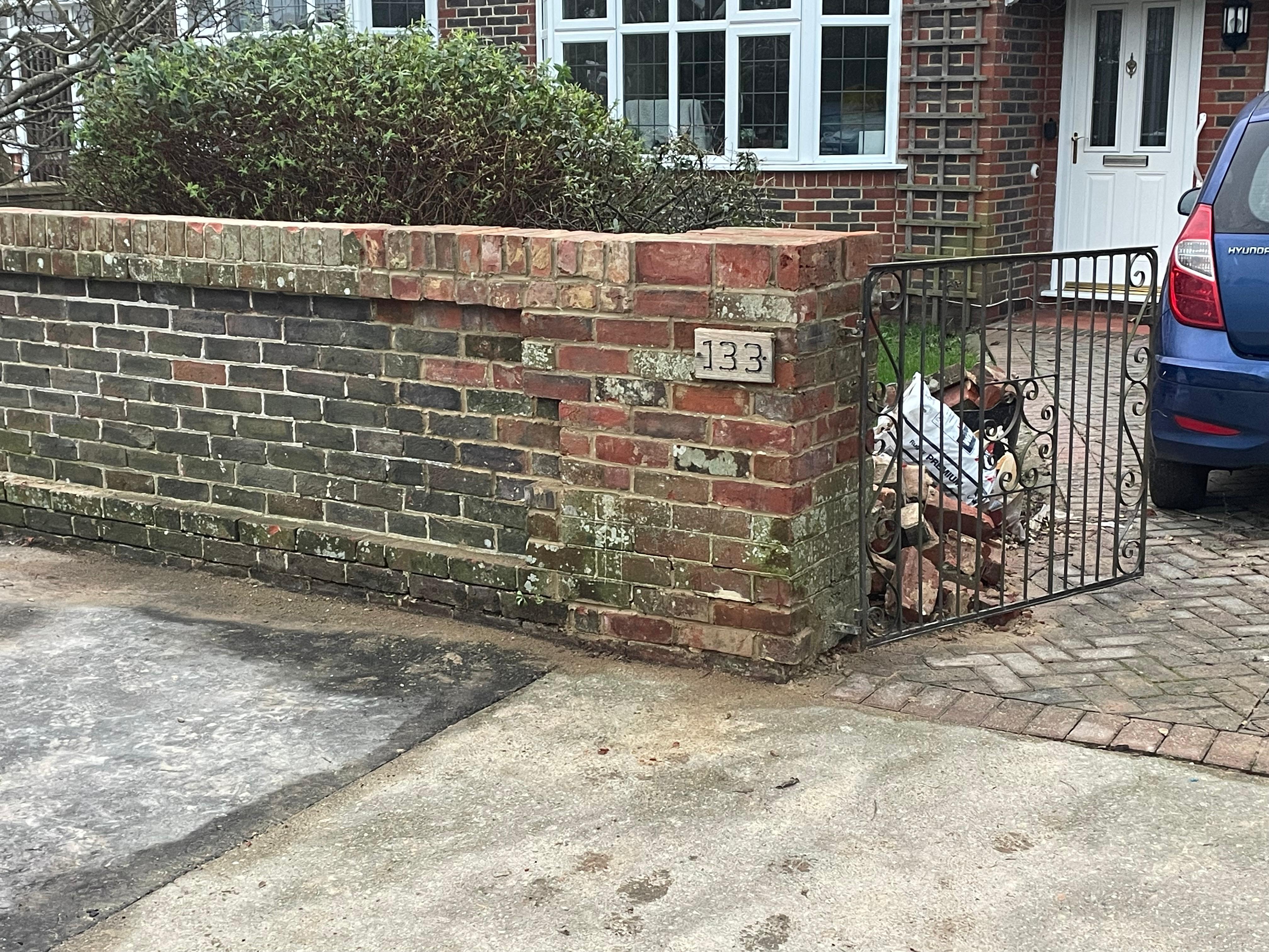 Rebuilt front garden brick wall with gate reattached