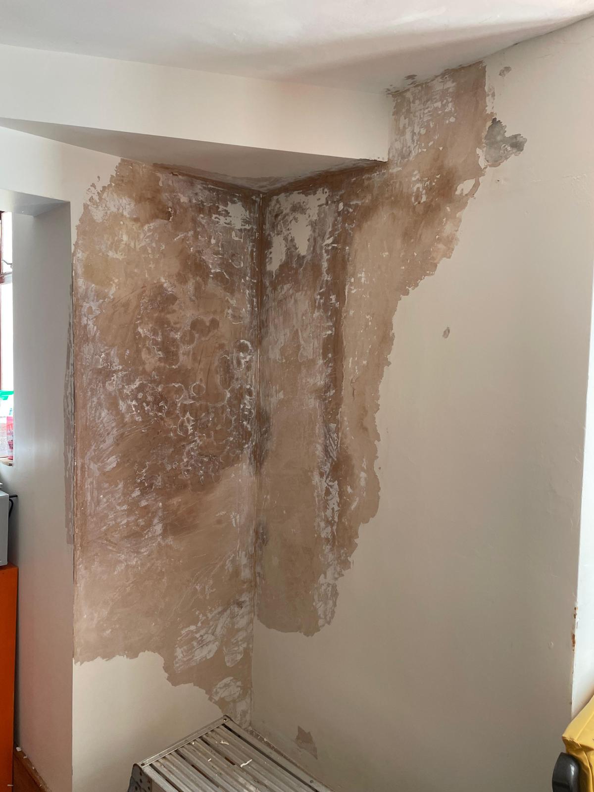 Damaged interior wall with peeling plaster