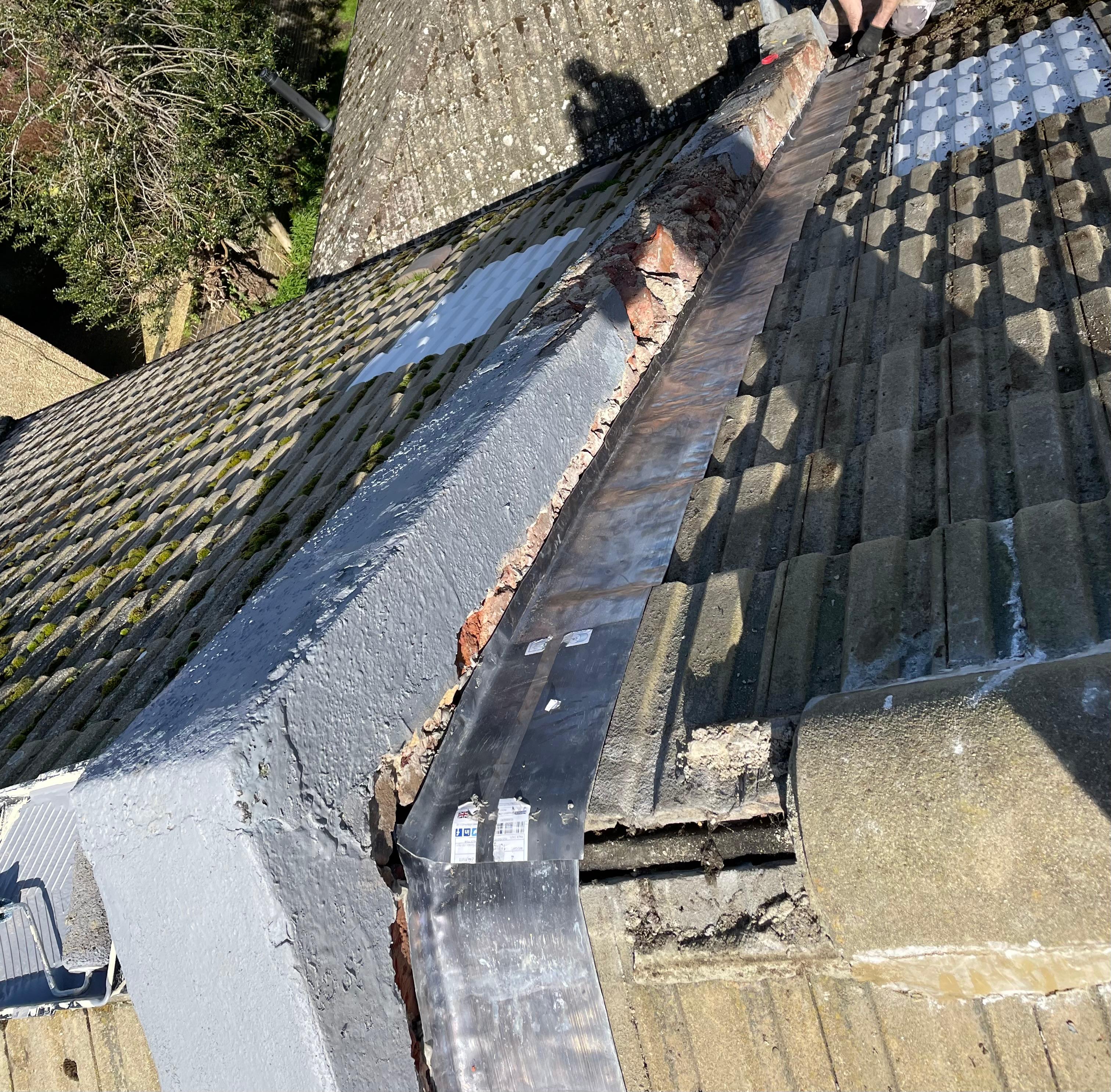 Damaged roof valley with cracked lead flashing